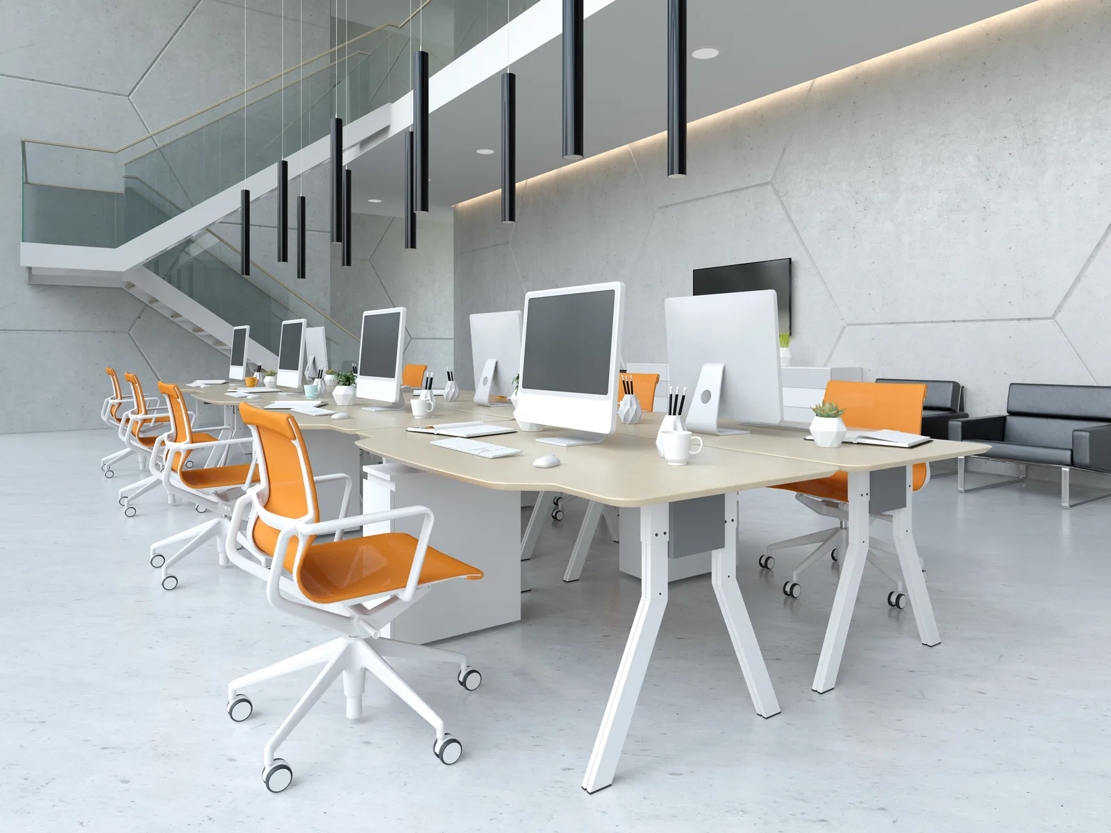 Desks with orange chairs in an open-plan office